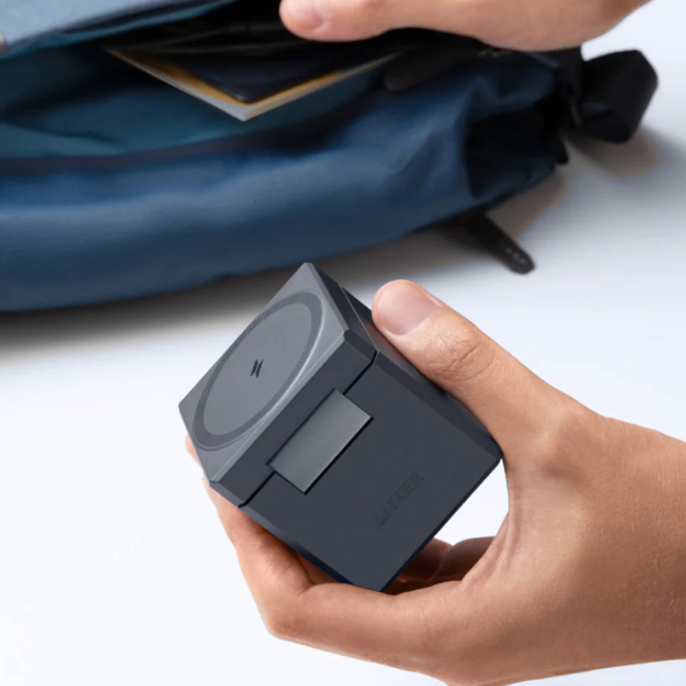 Portable Anker MagSafe cube charger for travel with backpack in background