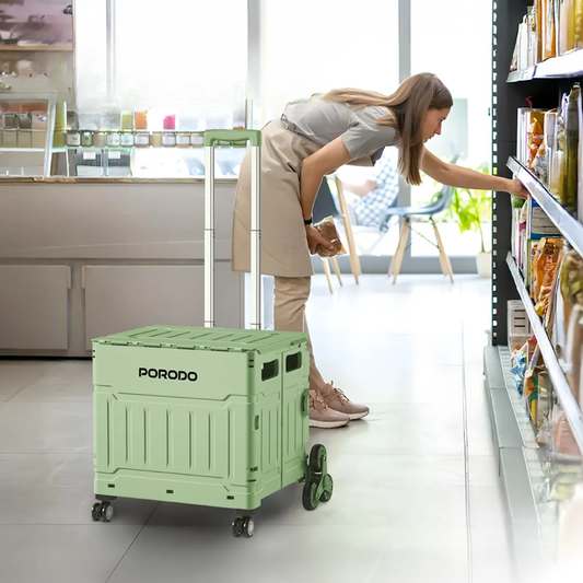 Woman using Porodo light green collapsible wagon cart for shopping in retail aisle