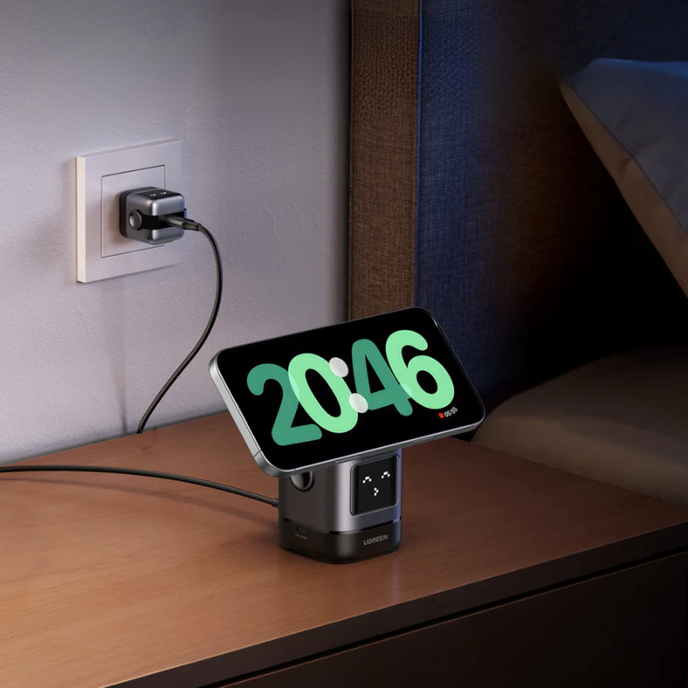 Ugreen magnetic charger on nightstand displaying digital clock and smiling robot face