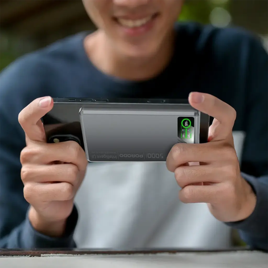 Person using gray Porodo 20W magnetic power bank attached to smartphone for gaming