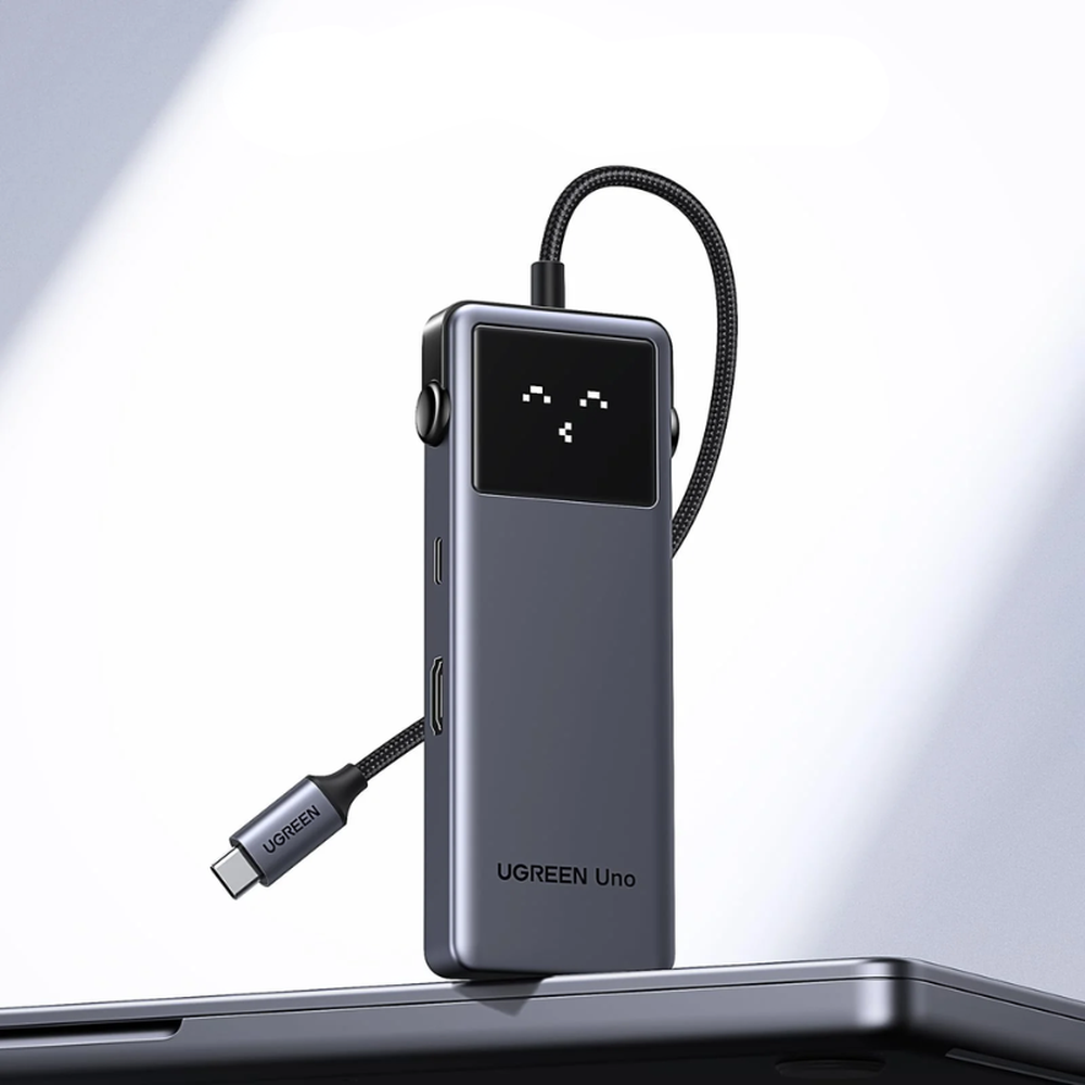 Compact Ugreen Uno hub standing on closed laptop lid