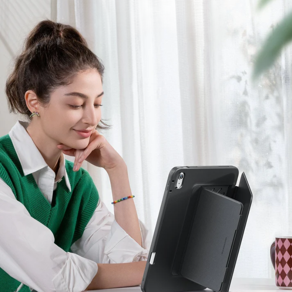 Woman using black ESR iPad flip case in vertical browsing mode