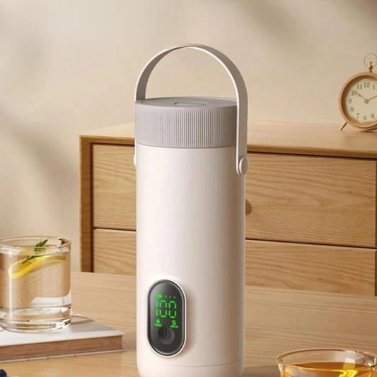 White rechargeable kettle displaying 100 degrees next to lemon water and tea