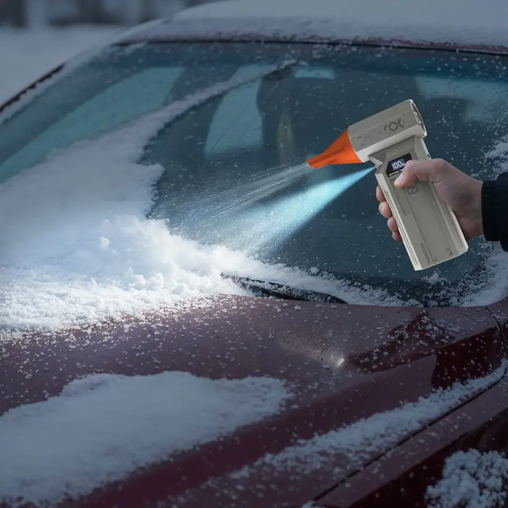 Person using Porodo dust blower to clear snow from car windshield