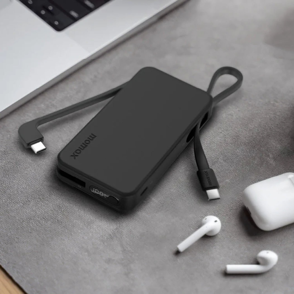 Black Momax portable charger with dual built-in cables charging laptop