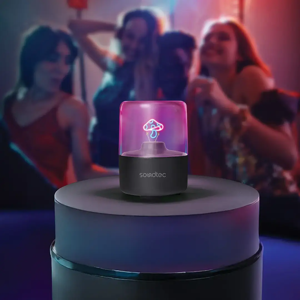 Wireless Bluetooth speaker with glowing mushroom light for party ambiance and dancing scenes