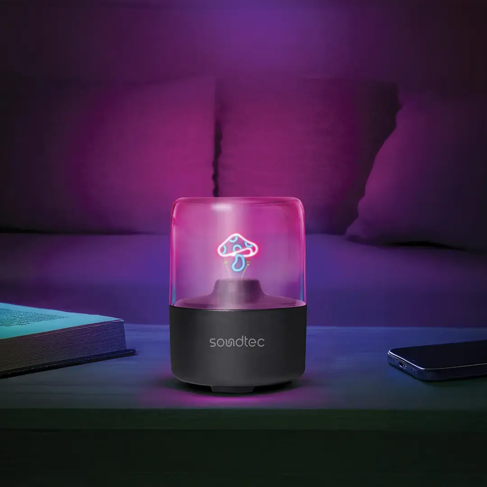 Compact speaker with soft purple ambient glow on nightstand for bedroom relaxation