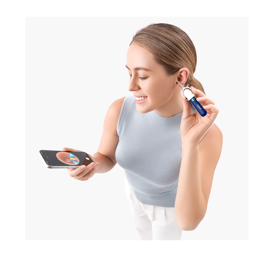 Woman using Bebird ear inspection tool with live smartphone feed of ear canal