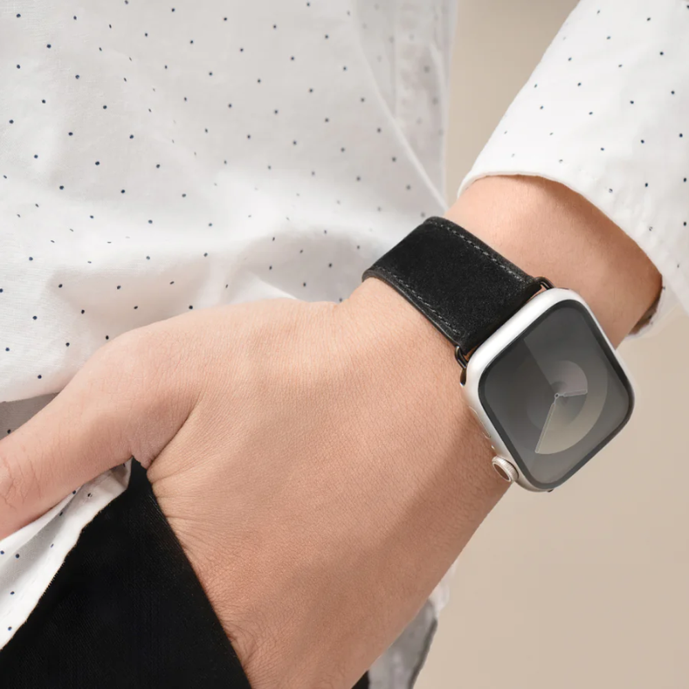 Brown leather Apple Watch band on wrist showing fit and smooth texture