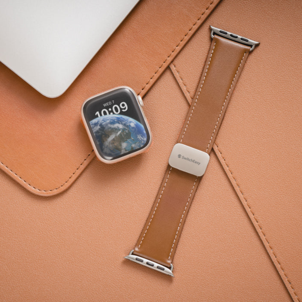Tan leather Apple Watch band flat lay with matching wallet accessory