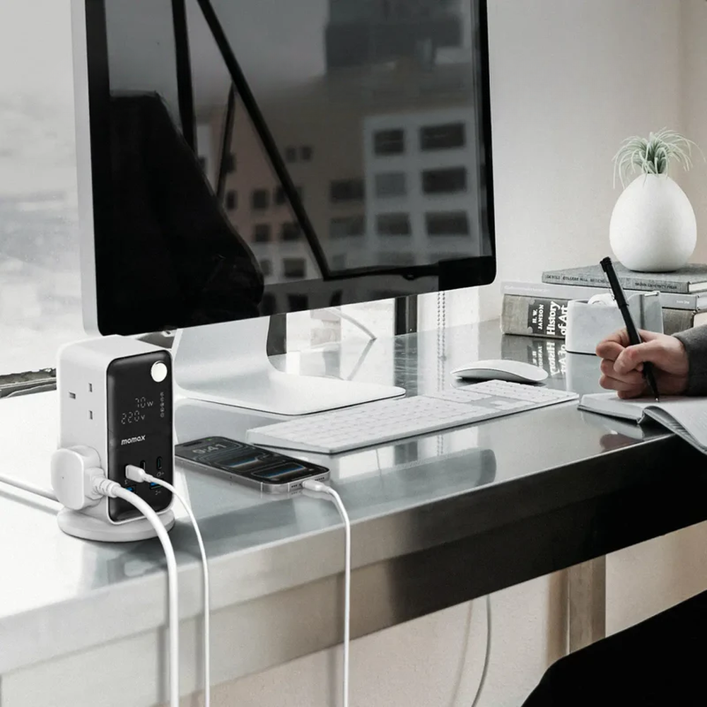Momax 70W digital power tower on office desk powering multiple devices