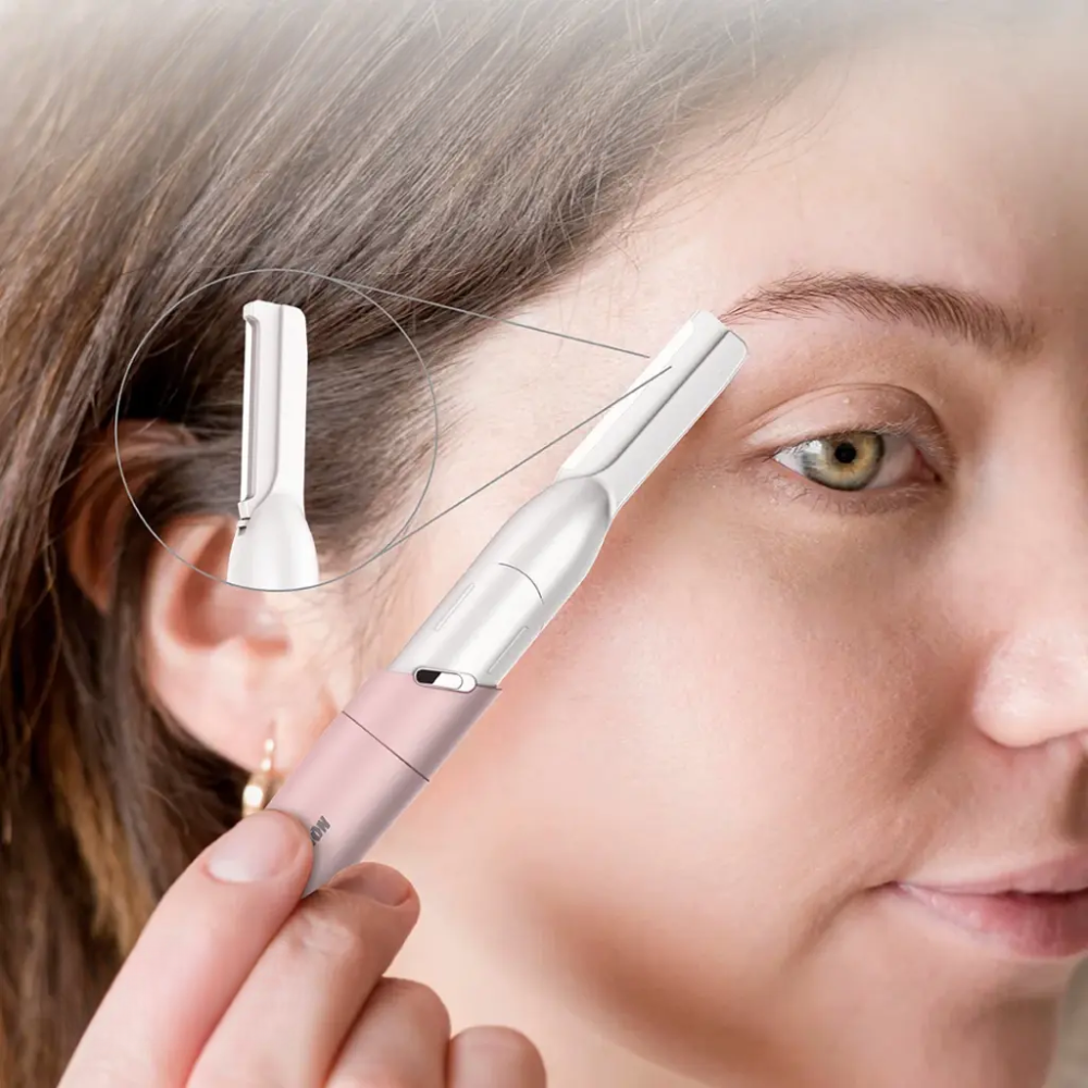 Person using pink Green Lion eyebrow trimmer for precise grooming