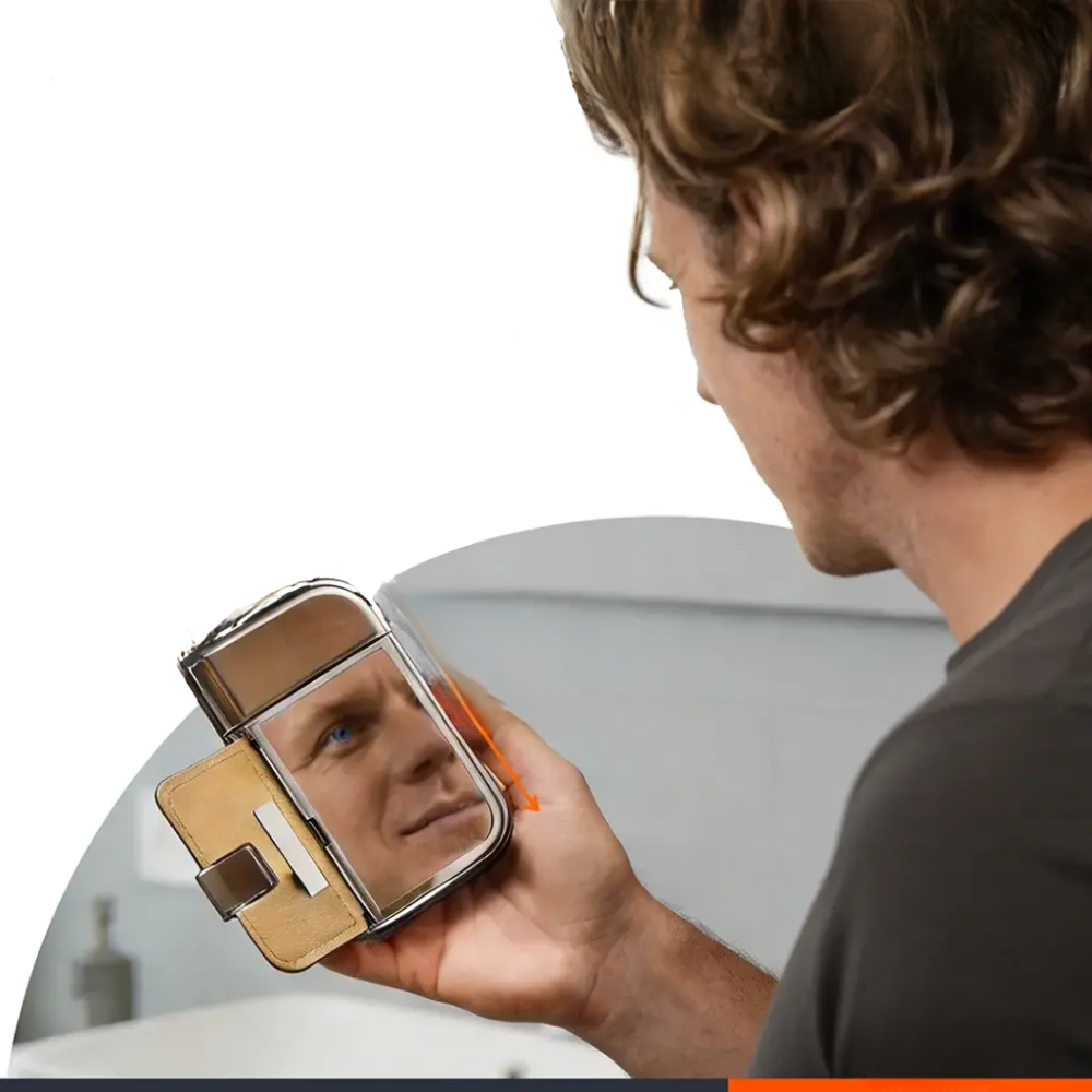 Man using Porodo shaver kit flip-down mirror for beard grooming in bathroom