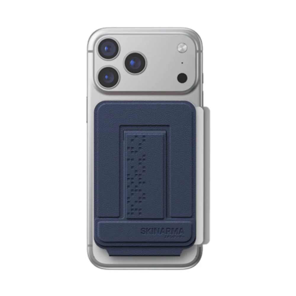 Navy blue Skinarma magnetic card holder with Braille texture on silver MagSafe phone
