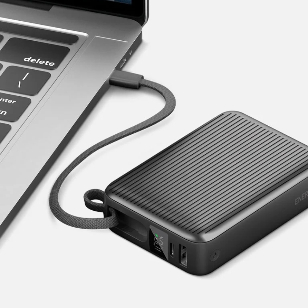 Black Energea 20000mAh power bank with digital display charging silver laptop via braided cable