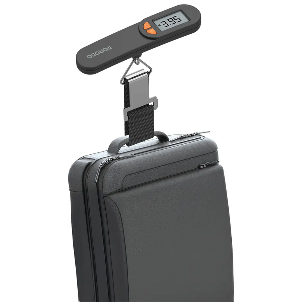 Black Porodo luggage scale hanging from gray soft-sided suitcase handle