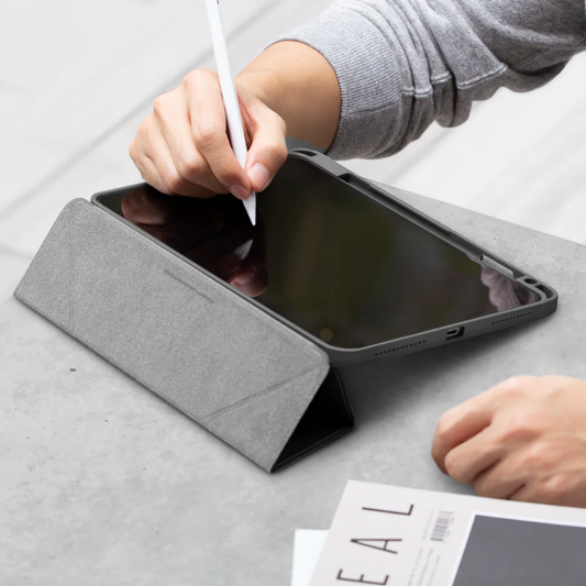 Person using dark gray iPad Pro case with Y-fold stand and white stylus