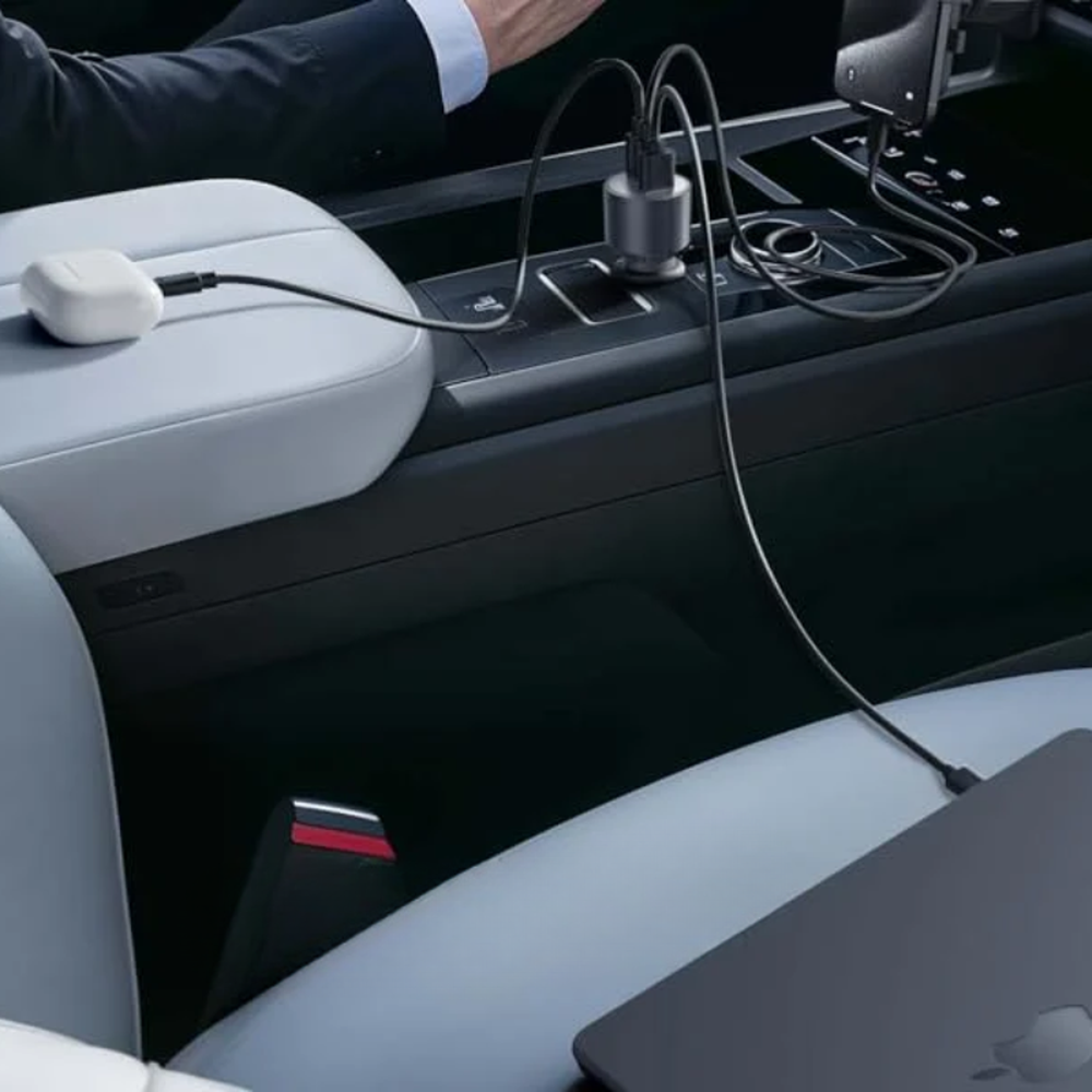 Anker 167.5W car charger powering laptop and earbuds in vehicle interior