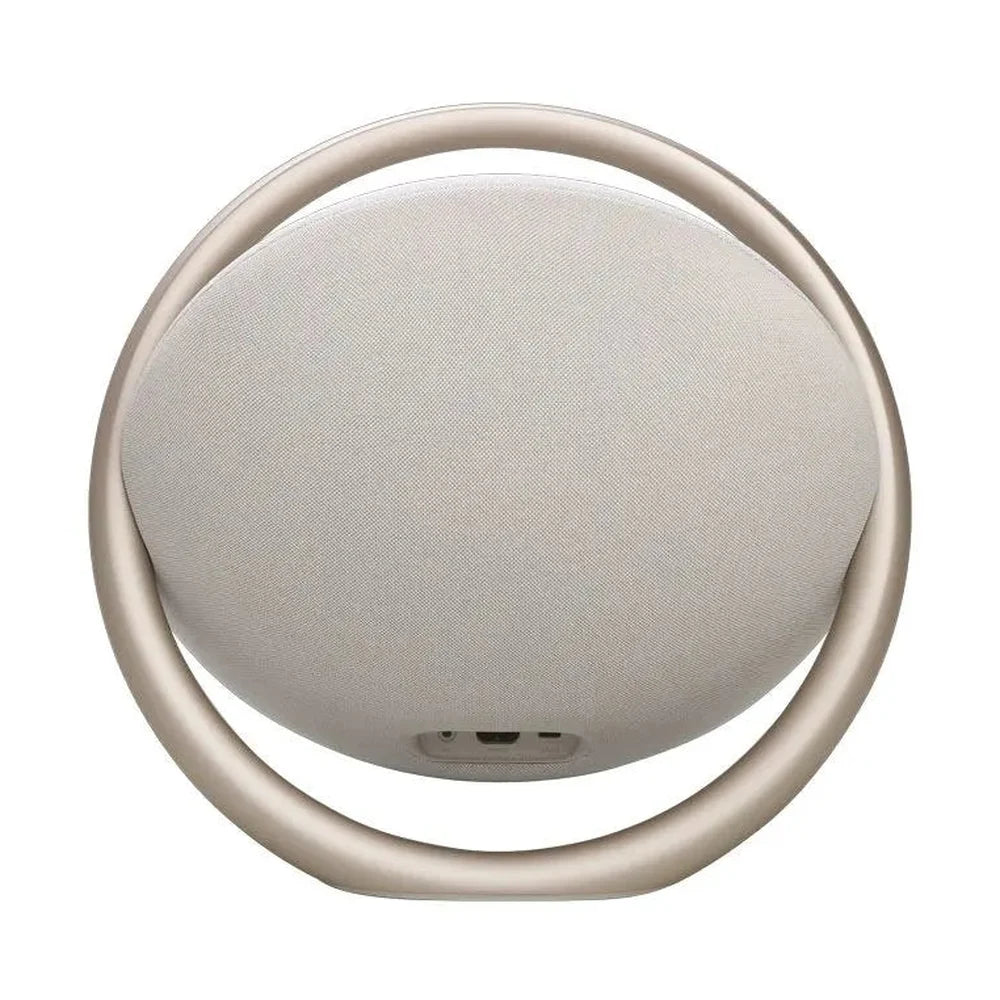 Back of beige Harman Kardon speaker showing charging and audio input ports