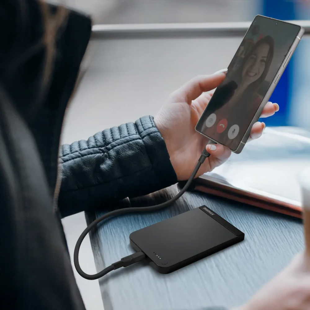 Black magnetic power bank on table during video call use case