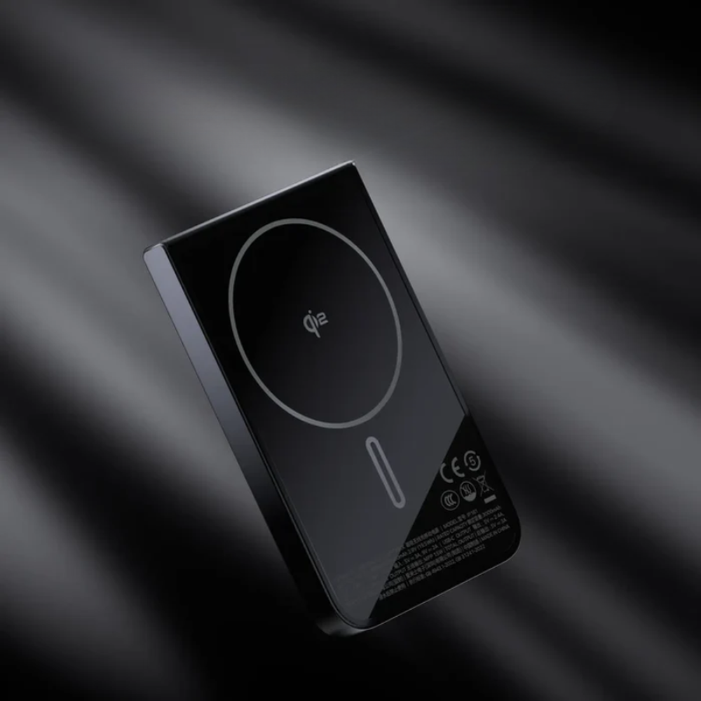 Black Qi2 wireless charging power bank with regulatory symbols