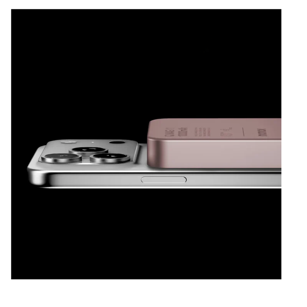 Rose gold Momax Q.MAG X1 magnetic power bank attached to silver smartphone side view