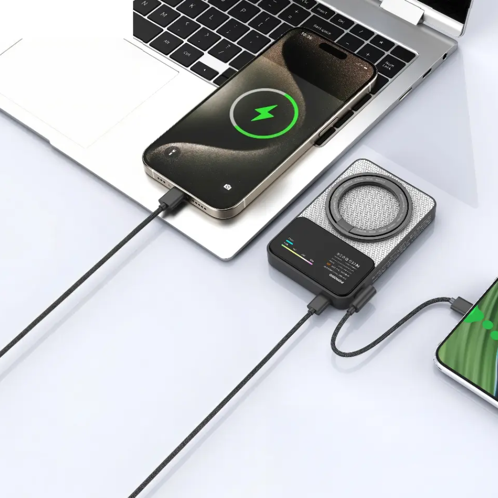 Porodo magnetic power bank charging smartphone and laptop simultaneously on white desk with braided USB-C cables