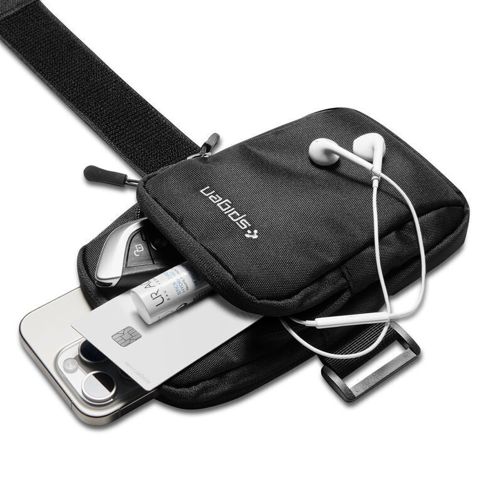 Spigen running armband holding phone, card, keys, and earphones for workouts