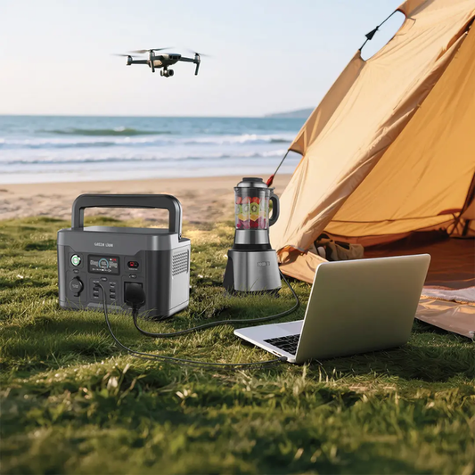 Green Lion 600W power station powering laptop and blender at beach campsite