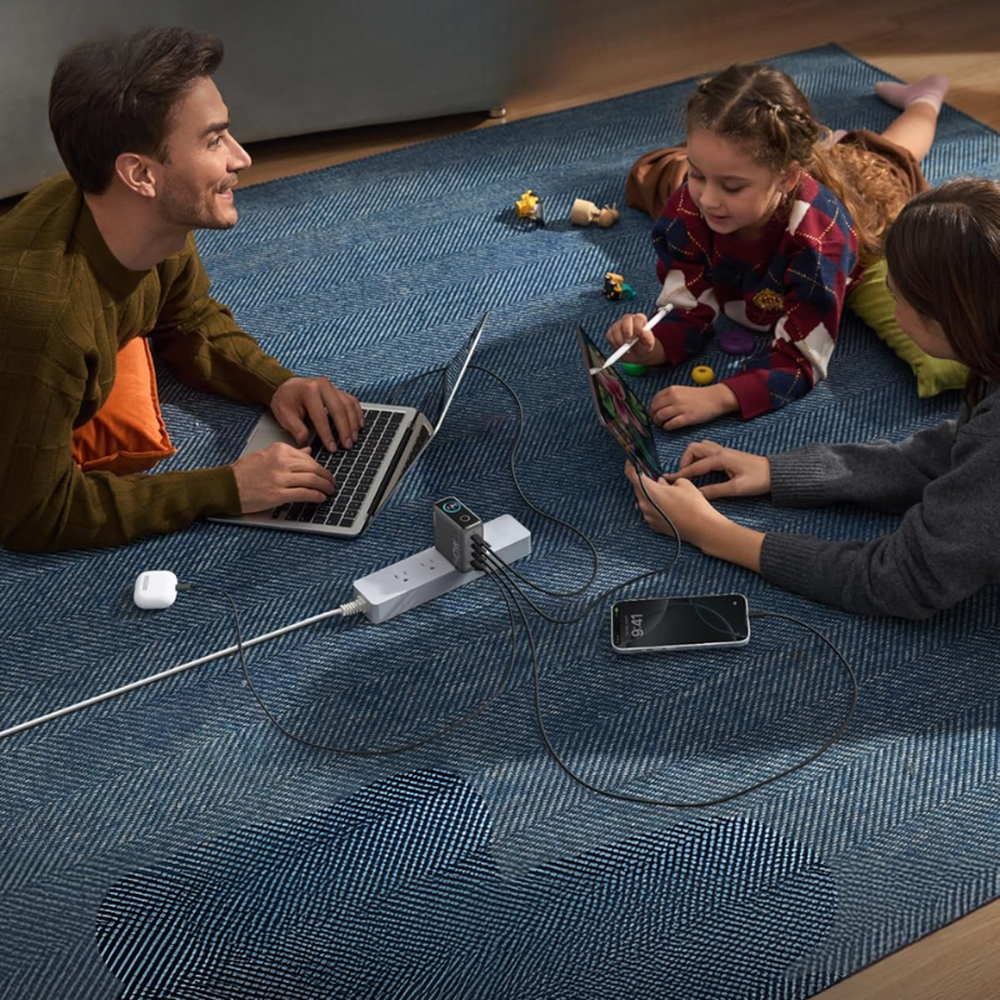 Family charging multiple devices simultaneously using Anker 140W multi-port wall charger