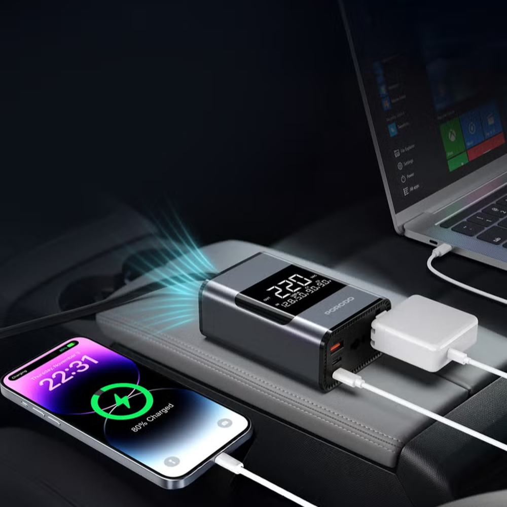 Porodo 200W car power inverter charging laptop and phone on center console