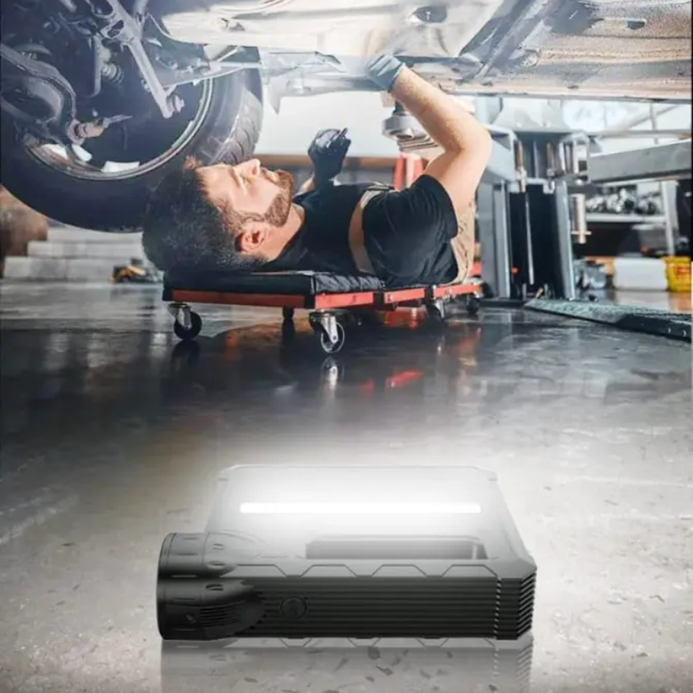 Black rugged multifunction jump starter with flashlight and grip handle for car emergencies