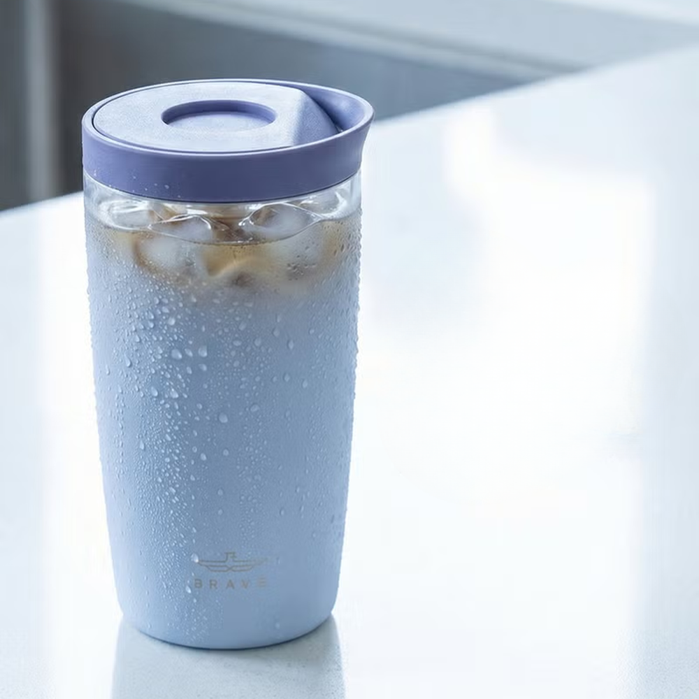 Brave light blue travel mug with ice cubes and condensation