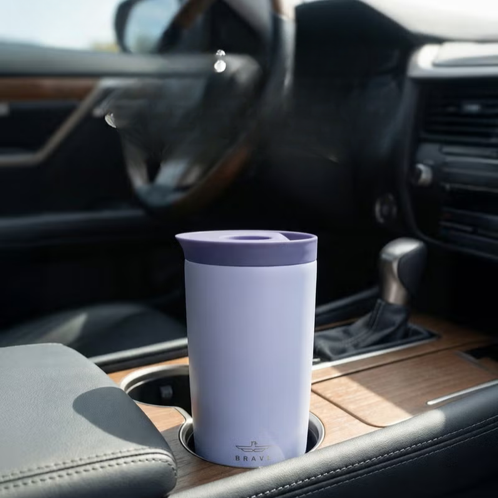 Lavender Brave travel mug in car cup holder with steam rising