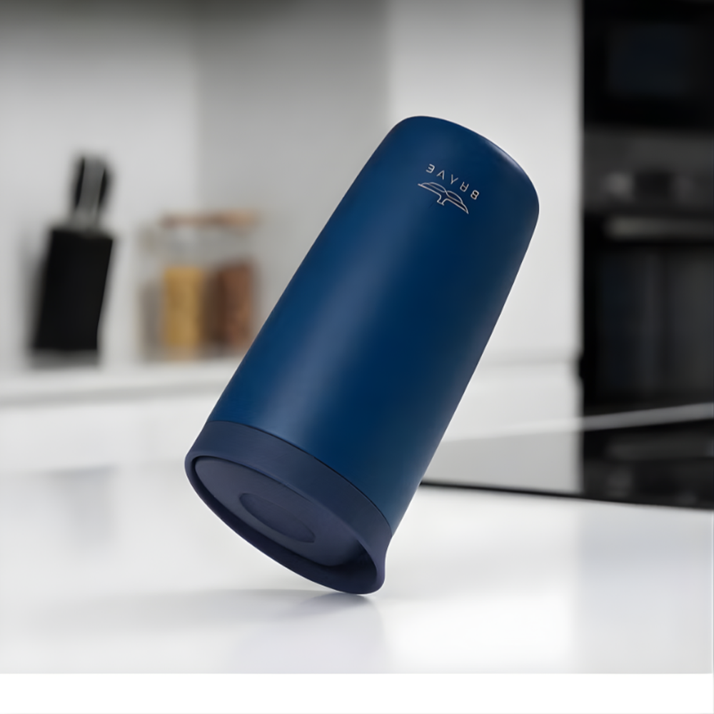 Brave navy blue travel mug in motion showing stability on countertop