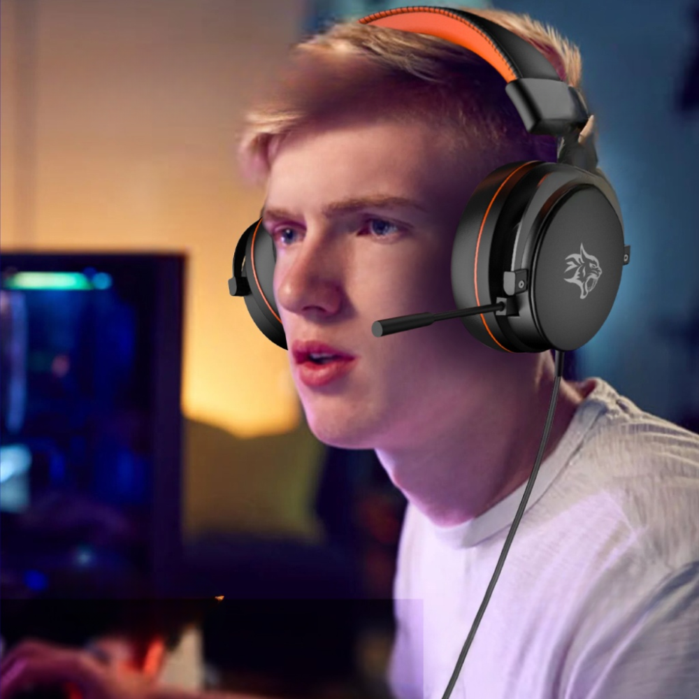Gamer wearing black over-ear headset with orange accents in profile