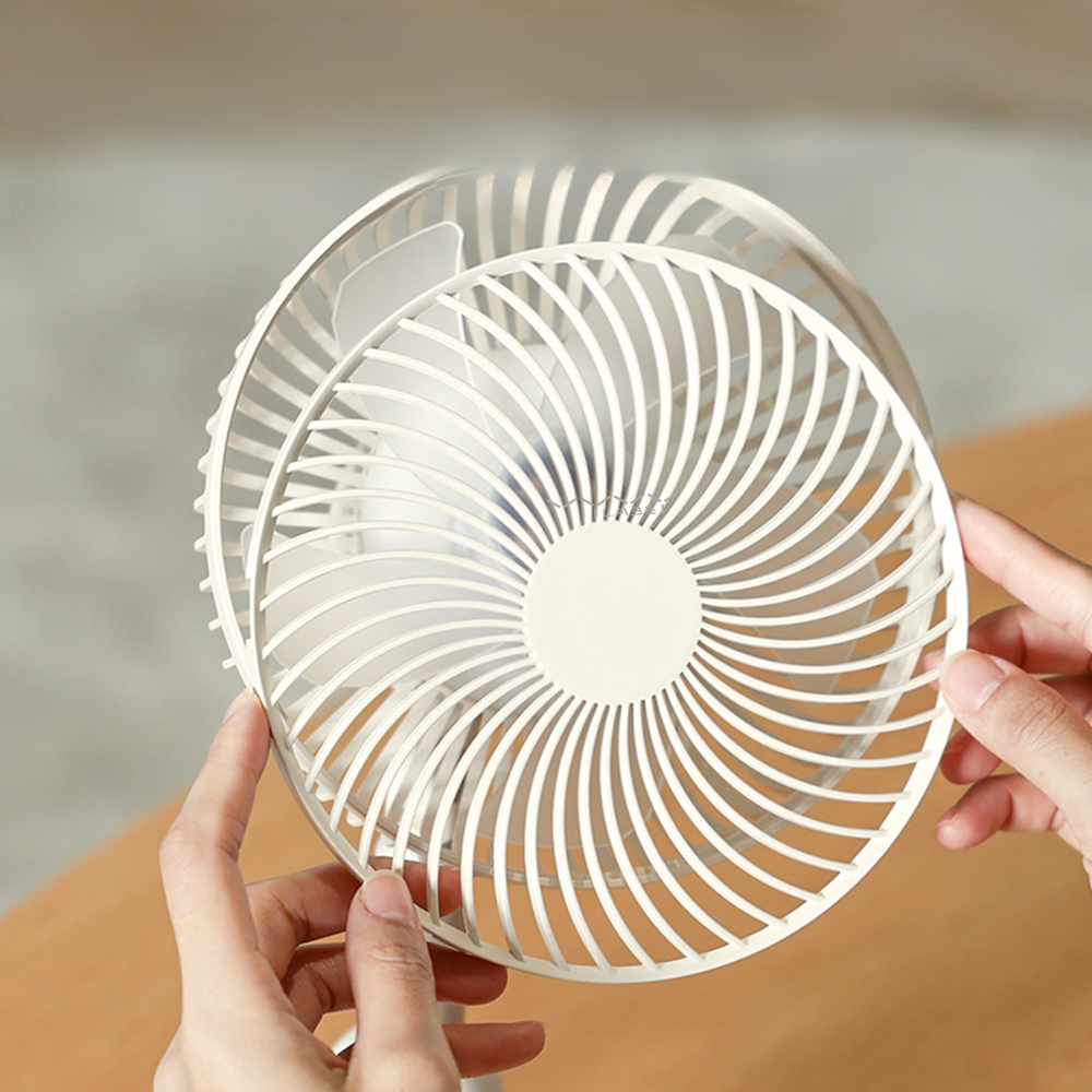 White Vyvylabs portable camping fan close-up showing circular grille and internal blades