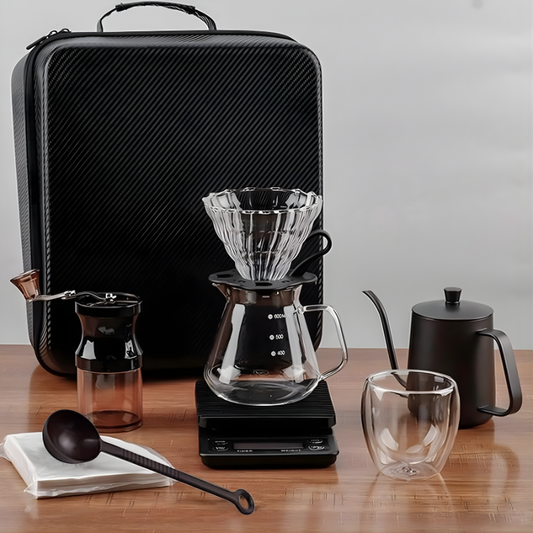 Complete V60 coffee travel kit on wooden table with grinder and carafe