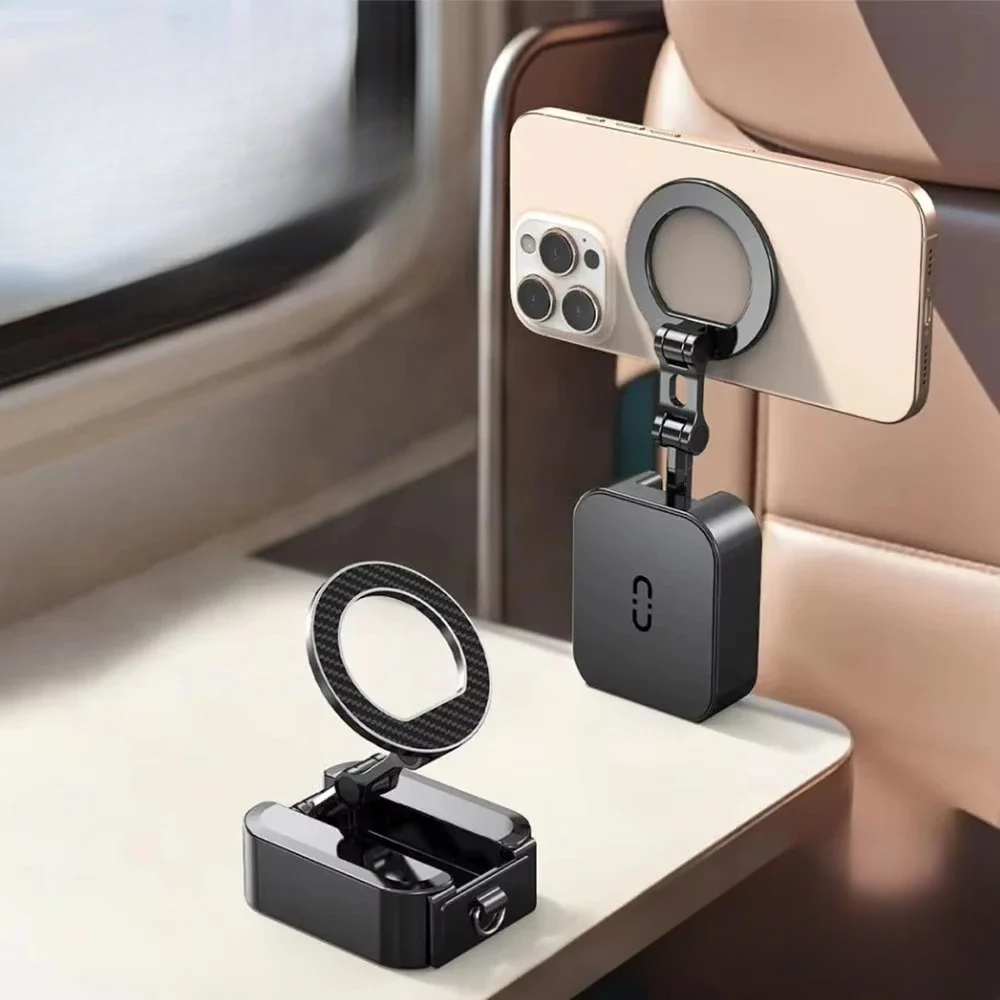 Black MagSafe folding phone holder with carbon fiber ring mounted on car seat table