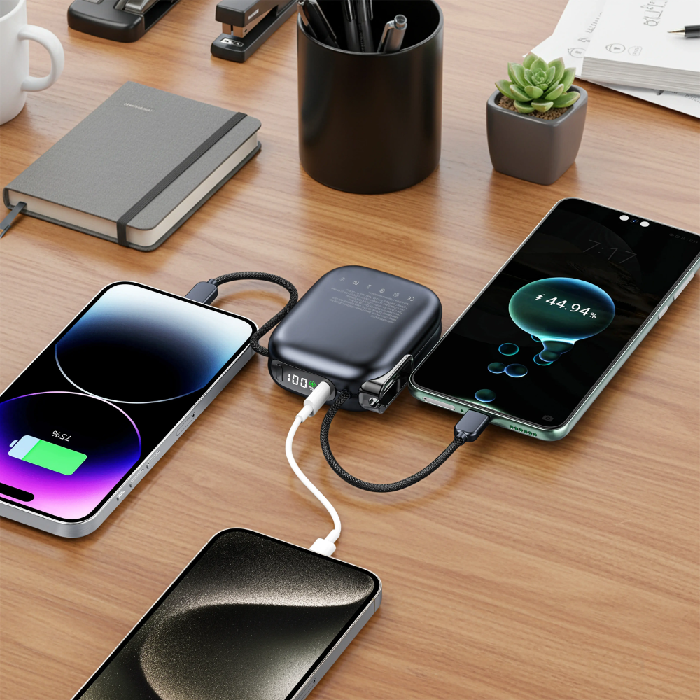 Black 10000mAh Porodo power bank with built-in cables charging three smartphones simultaneously