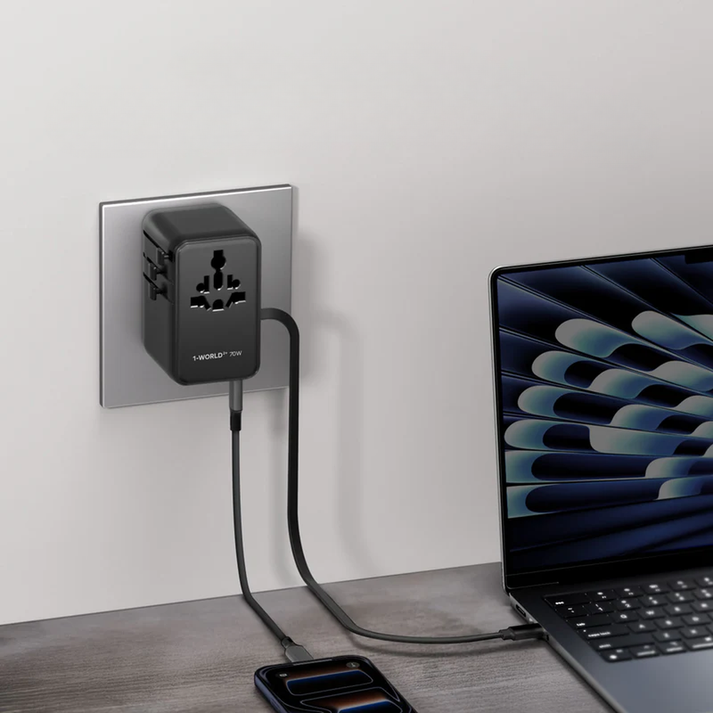 Momax 25W travel adapter simultaneously charging smartphone and laptop