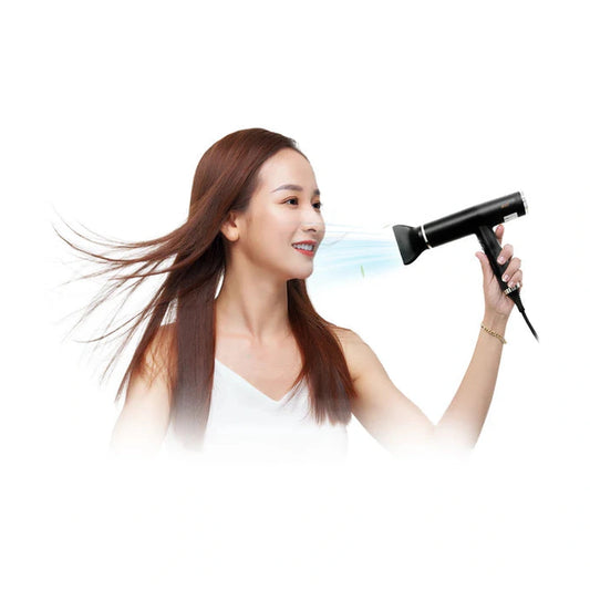 Woman styling long brown hair with Bolt high-speed hair dryer