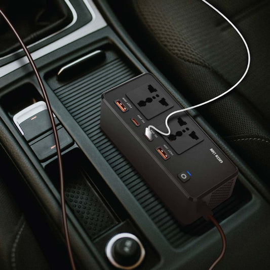 Car power adapter with multiple outlets and USB ports on a car dashboard.