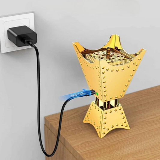 Charging gold Bakhoor burner connected to 5V USB wall outlet with LED indicator
