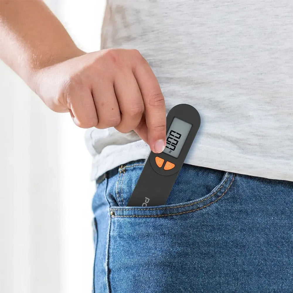 Slim black Porodo digital travel scale in jeans pocket with orange button
