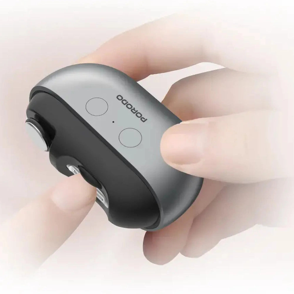 Hand holding compact Porodo electric nail trimmer with LED light and USB-C charging