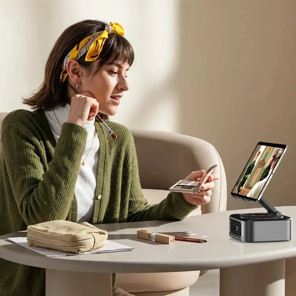 Woman using black Porodo speaker and power bank tablet stand with vinyl record design