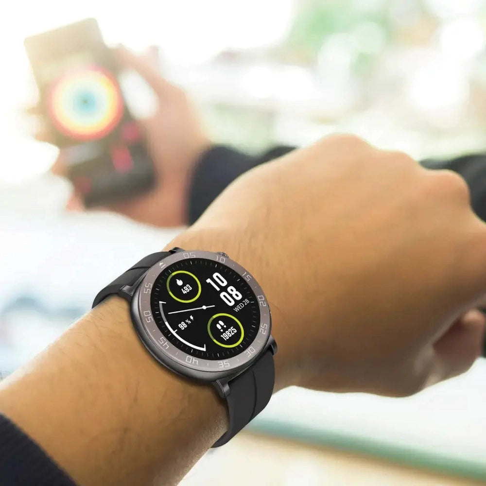 Person wearing black Porodo Salud smartwatch on wrist displaying step count and battery gauge