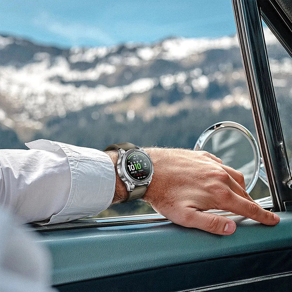Silver Powerology Titan watch with tan strap on wrist in mountain landscape