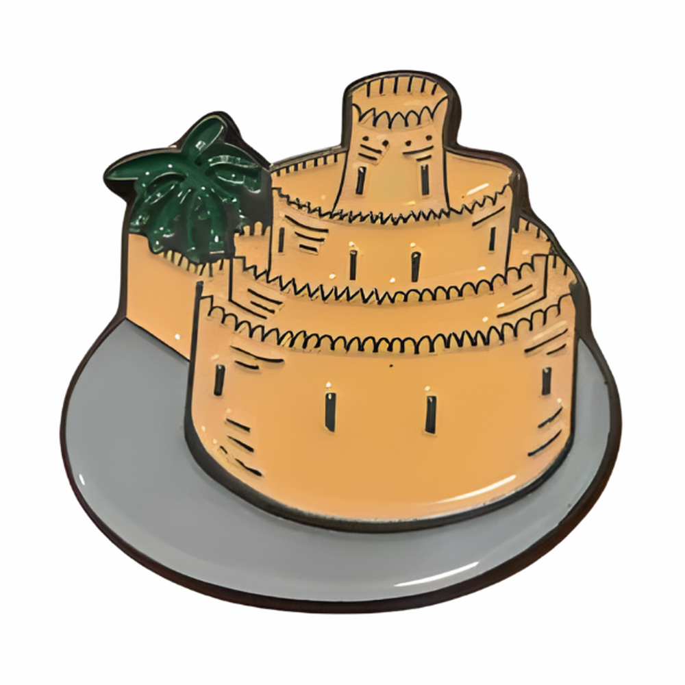 Qasr al Muwaiji metal badge with tan-orange castle design, green palm tree detail, and glossy finish